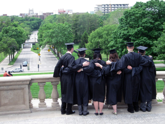 graduates in black robes standing together